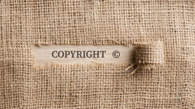 rough linen fabric with a torn section in which the word copyright is written