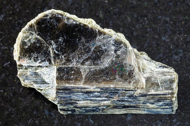 Rough muscovite mica stone on dark background