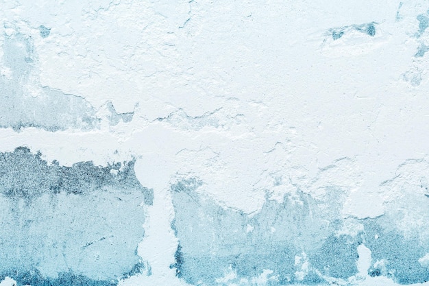 Rough old plaster on a brick wall White blue abstract background