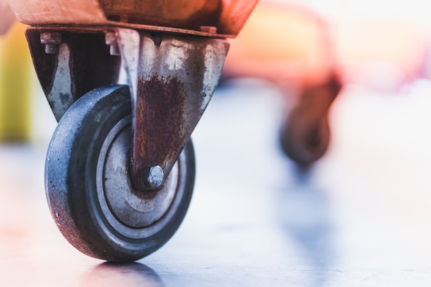 Rough and rustic wheel of shopping cart with beautiful blurred background