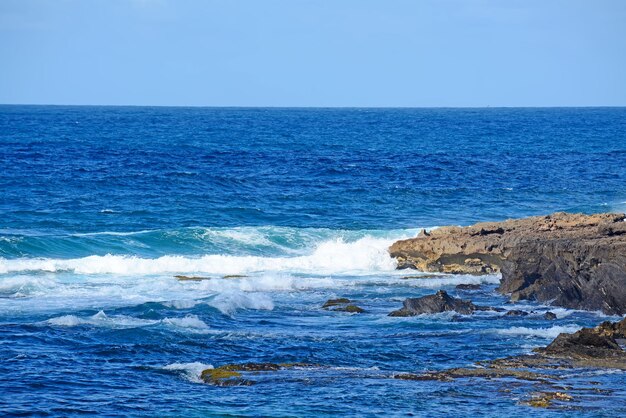 Rough sea and brown rocks in Argentiera Sardinia