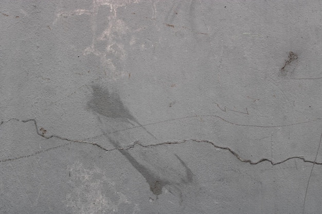 Rough texture of an old gray cracked wall on the wall