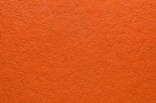 Rough texture of orange paper with fibers, macro photography. Close-up paper background top view