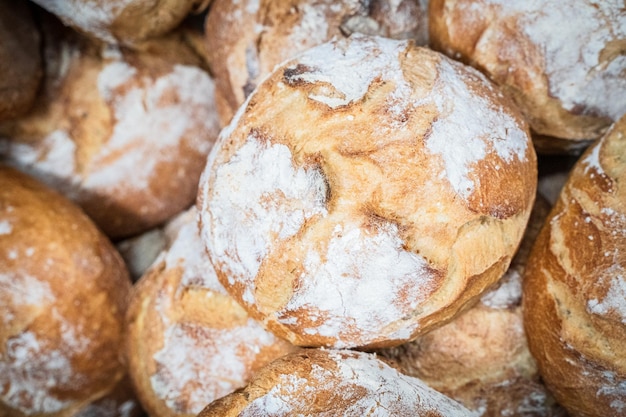 Round artisan breads with flour