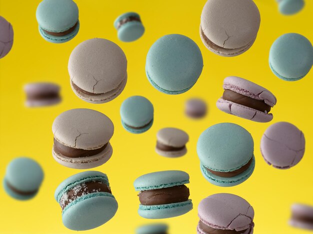 Round baked macarons levitate on a yellow background, full frame