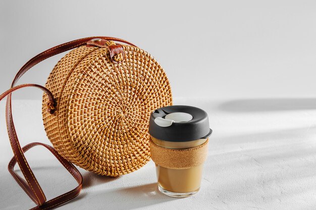 Round bamboo bag with reusable coffee mug. sustainable lifestyle. zero waste, plastic free concept