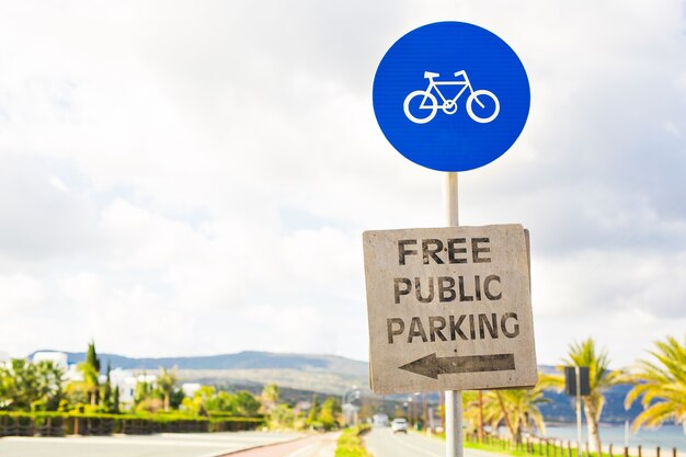 Round bicycle lane sign against a blue sky