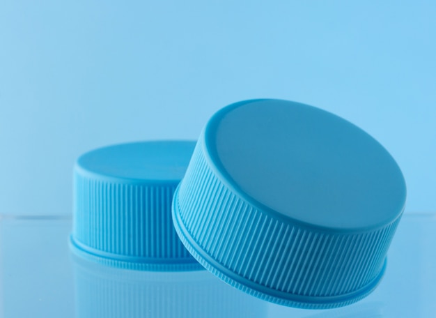 Round blue plastic cream jar isolated on white background