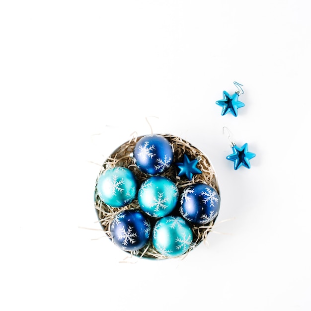 Round box with bright blue christmas balls on white background.