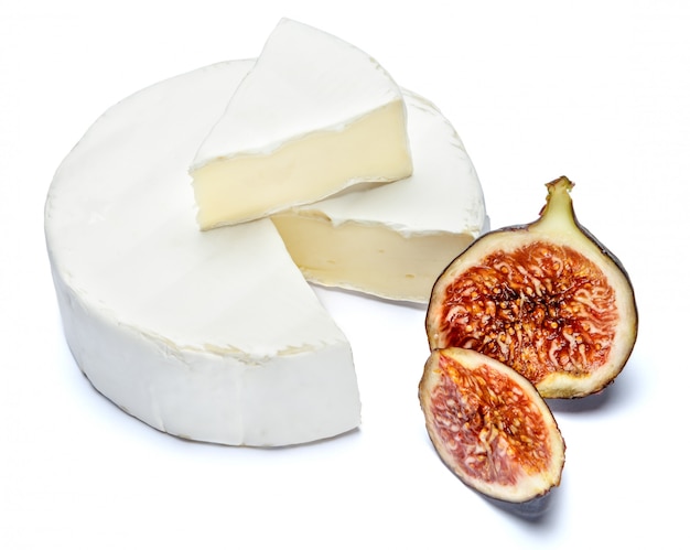 Round brie or camembert cheese on a white table