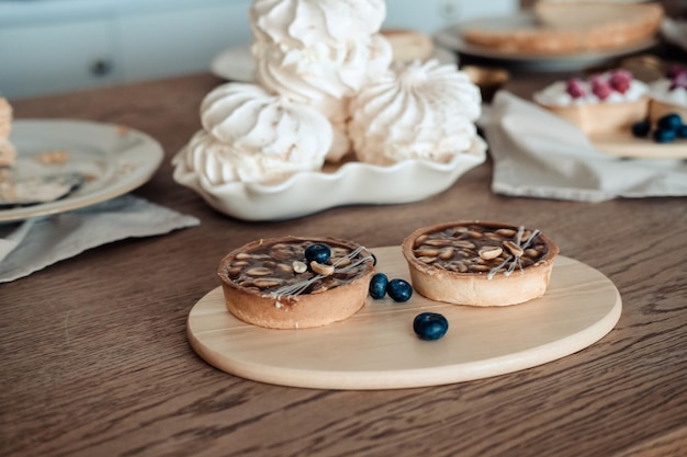 Round brown cake with nuts and caramel Still life with cakes on the table closeup