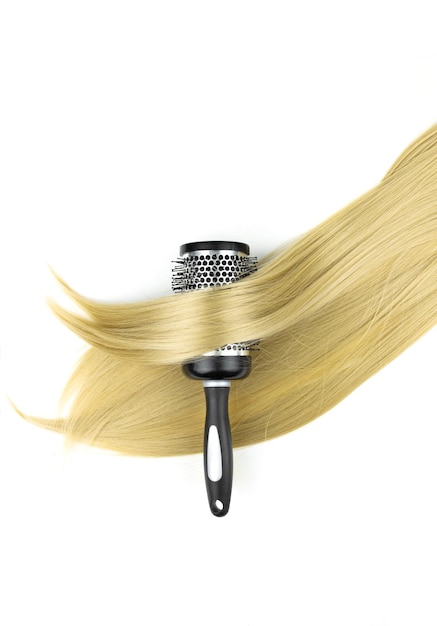 Round brushing comb and long blond hair Drying long blond hair with round brush