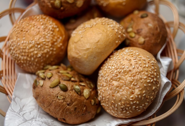 Round buns with bran nuts and sesame seeds bread in the basket\
wholegrain bun