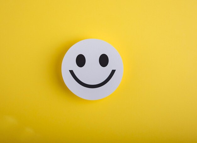 A round button with a smiley face on it