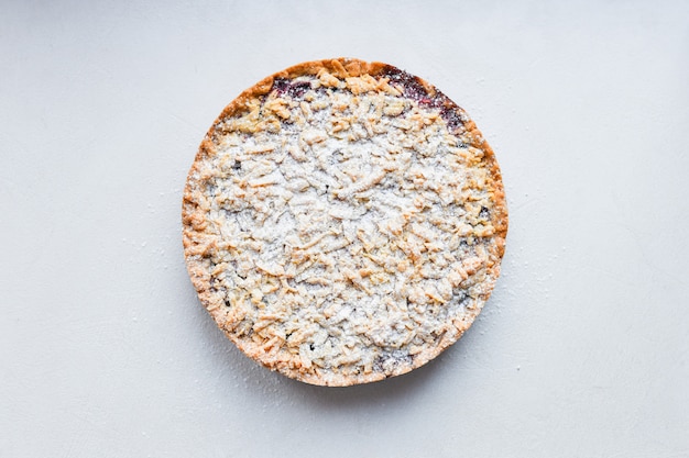 Round cake on a white surface. view from above. pasipan powder