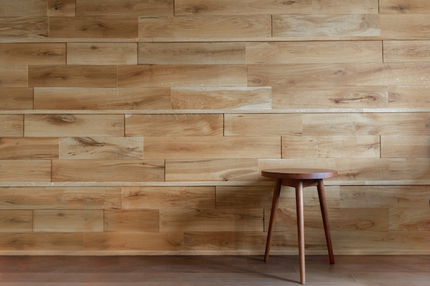 Round chair beside wooden wall