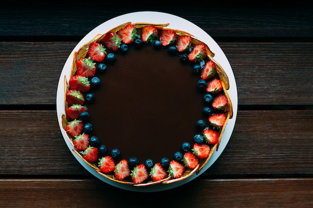 Round chocolate cake with fresh berries