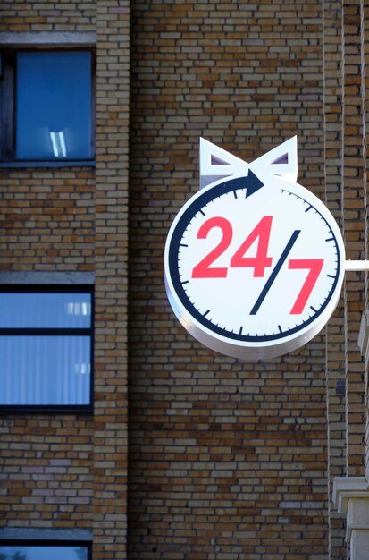 Round the clock sign facade brick house