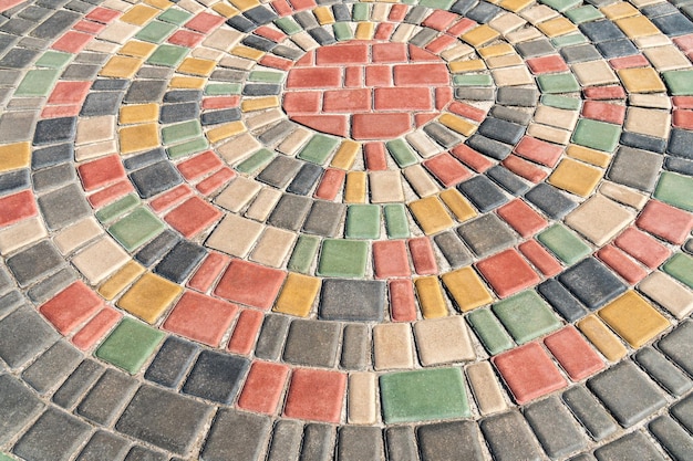 Round colorful pavement on sunny day in public park as background