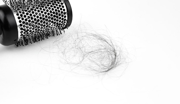 Round comb with fallen hair Close up White background Hair fall hair brush with hairs