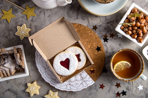 Round cookies with heart-shaped jam in a gift box 