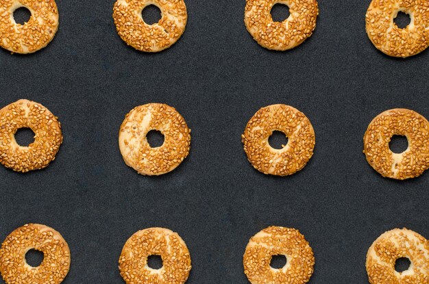 Round cookies with sesame seeds on a black background Confectionery product