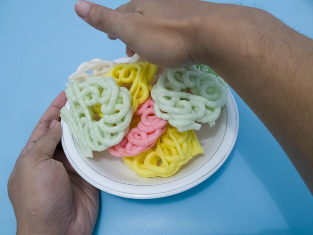 Round crackers with a white green red and yellow texture