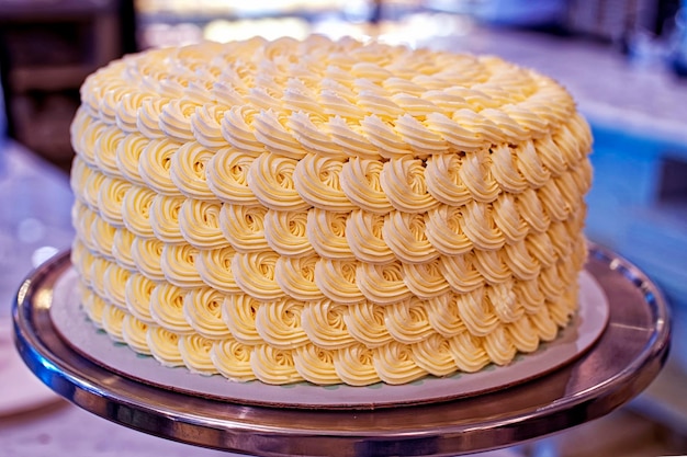 Round creamy cake with white cream on the bakery storefront