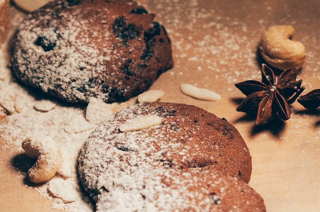 Round crispy chocolate cookies with spices and nuts on a table