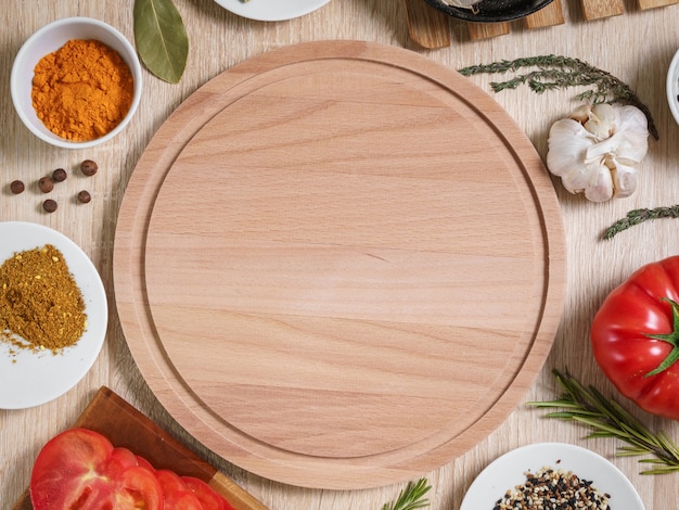 Round cutting board with food ingredients for cooking culinary dishes