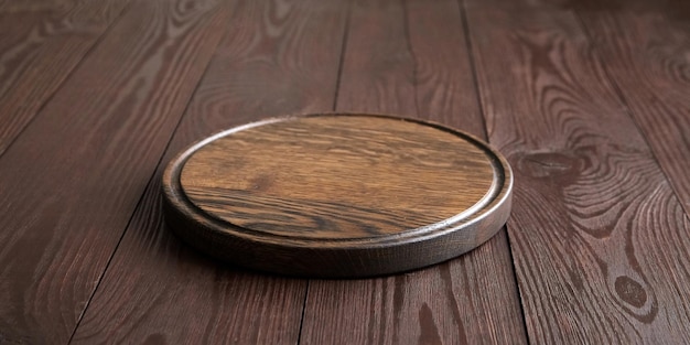 Round cutting board with groove on wooden table