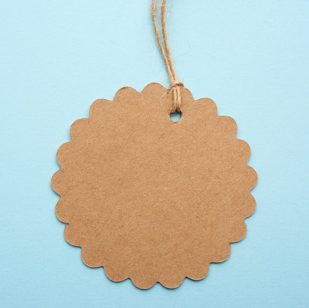 Round empty brown paper tag tied with string