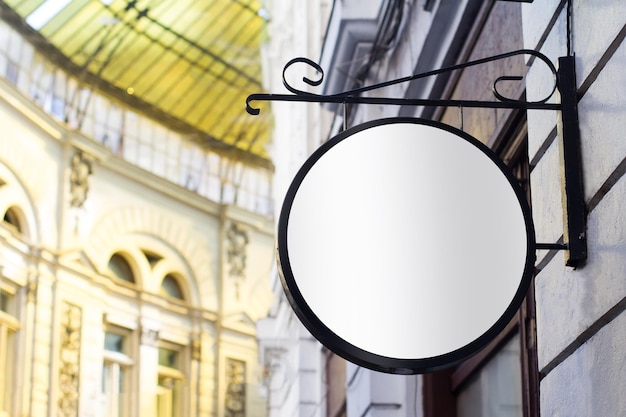 Round empty signboard on a building with classical architecture