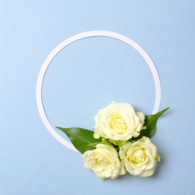 Round floral frame border made of paper circle, rose flowers petals, green leaves