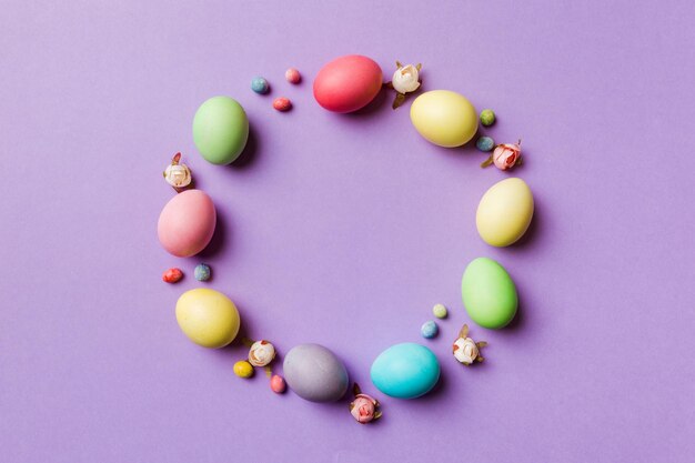 Round frame Multi colors Easter eggs on colored background Pastel color Easter eggs holiday concept with empty space for you design