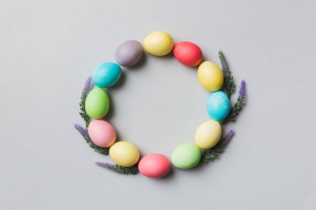 Round frame Multi colors Easter eggs on colored background Pastel color Easter eggs holiday concept with empty space for you design