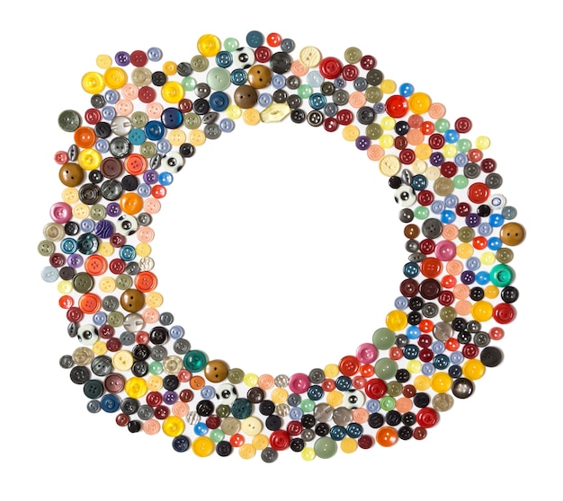 Round frame  multicolored plain buttons chaotically arranged on a white surface