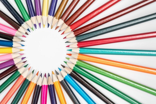 Round frame of pencils pointing to the center, on a white background
