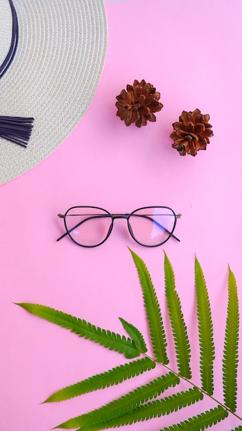 Round glasses in the photo in minimal summer style on a pastel pink color background.