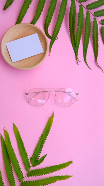 Round glasses in the photo in minimal summer style on a pastel pink color background.