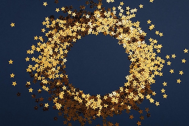 Photo round gold frame or border of random scatter golden stars flat lay