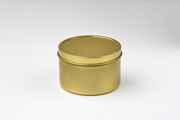 Photo round golden jar stands on white background in studio