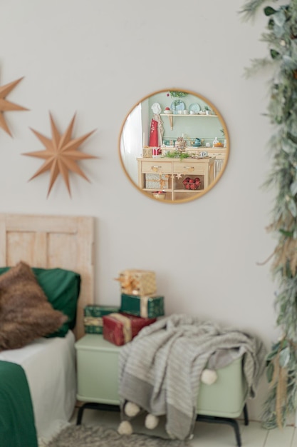 Round golden mirror in bedroom. Christmas decorations