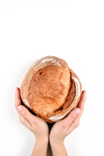 Round homemade bread in hands, on an isolated background