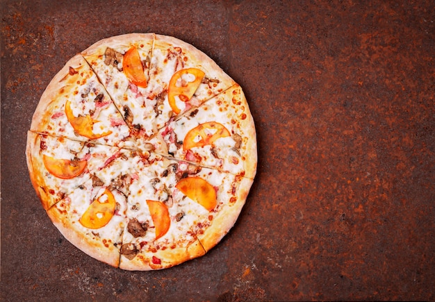 Round Italian pizza bbq on a rusty metal desk top view, empty space for text.