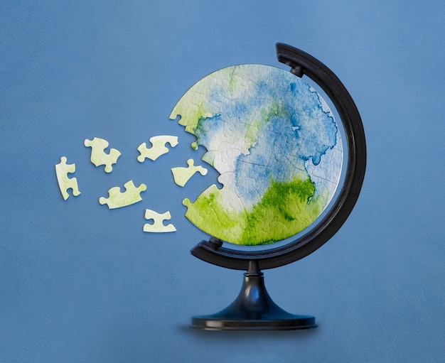 round jigsaw puzzle inserted in globe stand with unconnected pieces. Protecting the planet concept