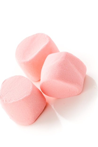 Round large pink marshmallows on a white backgrouns.