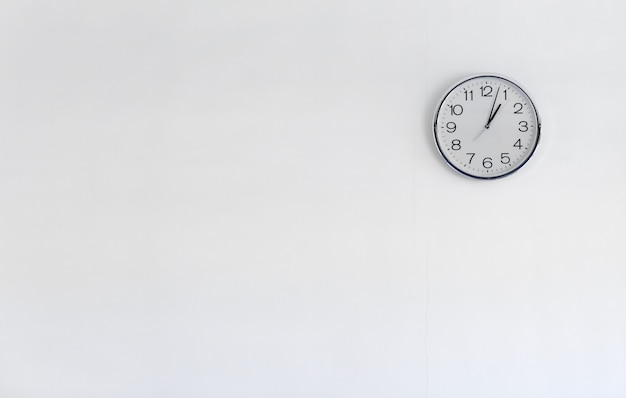 Photo round metal clock on white wall