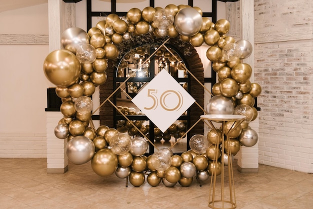 Photo the round photo zone is decorated with gold and silver balls for the 50th birthday, the work of an aerodesigner