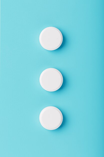 Round pill in a row on blue